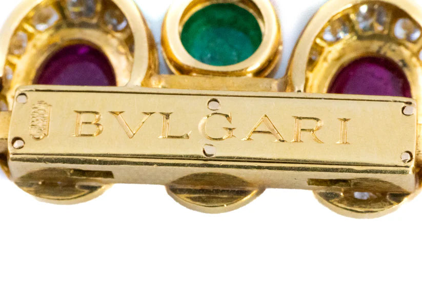483-40 FXIEXE | 18 K Bulgari, ruby emerald and diamond bracelet
